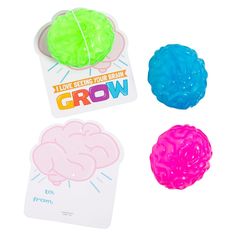 three different colored brain toys sitting next to each other on a white surface with the words grow above them