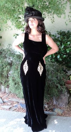 This listing is for a lovely black velvet gown dating to the early 1930s. Great wearable condition, I find no flaws with this dress. The unique little lace pockets are just that. You can put lipstick, jewelry, anything small in the actual pockets. It has a nice flow on the bottom and is bias cut making it fit all the right curves. Side metal zipper. Fits a size 6 or smaller. The model is actually a 2-4 and it looks great on her. Please inquire for specific measurements. Originally $395. Vintage Fitted Velvet Dress, Fitted Vintage Velvet Dress, Vintage Velvet Dress For Evening, Vintage Black Velvet Party Dress, Velvet Vintage Dress For Vintage Events, Vintage Black Velvet Dress For Party, Vintage Black Velvet Dress For Evening, Vintage Glamour Dress, Hollywood Glam Dress