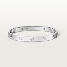 Cartier - LOVE bracelet, 4 diamonds - Bracelet White gold/Gold - LOVE bracelet, 18K white gold (750/1000), set with 4 brilliant-cut diamonds totaling 0.42 carats. Comes with a screwdriver. Width: 6.1 mm. Created in New York in 1969, the LOVE bracelet is an icon of jewelry design: a close fitting, oval bracelet composed of two rigid arcs which is worn on the wrist and removed using a specific screwdriver. The closure is designed with two functional screws placed on either side of the bracelet: yo Bracelet White Gold, Cartier Bracelet, Punk Vintage, Bracelet Love, Design Icon, Love Bracelet, Bracelet Collection, Cartier Love Bracelet, Love Bracelets