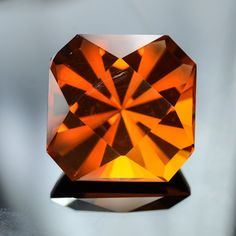 an orange diamond sitting on top of a table