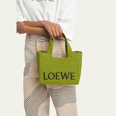 Loewe x Paula’s Ibiza raffia, leather, and fabric tote bag with signature logo across front  Flat top handles  Detachable, adjustable shoulder strap  Open top  Approx. 7.7"H x 9.4"W x 4.3"D Imported Designer Straw Bag With Top Carry Handle, Designer Straw Bag With Top Carry Handle For Vacation, Designer Summer Shoulder Bag With Top Handle, Designer Summer Bag With Top Carry Handle, Designer Green Bags For Summer, Designer Green Summer Bag, Designer Green Summer Bags, Designer Summer Bags With Intrecciato Weave, Designer Bags With Intrecciato Weave For Summer