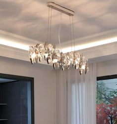 a chandelier hanging over a dining room table