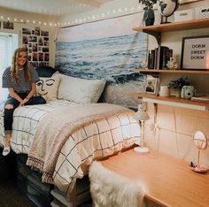 a woman sitting on top of a bed in a bedroom