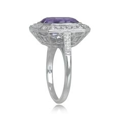 A geometric gemstone ring with a lively emerald cut natural kunzite with a pink saturation, weighing 7.22 carats. The center stone is bezel-set and surrounded by a halo of pave-set round brilliant-cut diamonds. Additional round brilliant cut diamonds are set along the shoulders, bringing the total diamond weight to approximately 0.53 carats. This ring was handcrafted in platinum and is decorated with an openwork under-gallery and fine milgrain.
The measurements of this ring, including the diamon Luxury Octagon Ring With Bezel Setting, Elegant Octagon Sapphire Ring With Bezel Setting, Modern Octagon Ring With Accent Stones, Modern Octagon Rings With Accent Stones, Art Deco Octagon Ring With Bezel Setting, Art Deco Octagon Bezel Set Ring, Modern Rings With Octagon Center Stone, Modern Octagon Rings With Center Stone, Art Deco Baguette Cut Gemstone Ring