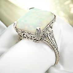 Vintage Estate 3.00 Carat Lab Created Opal Solitaire Filigree Ring. 925 Solid Sterling Silver. The Top Of The Ring Measures Just Over 1/2 Inch In Length. Set With One 14.5 x 12mm Lab Created Approx. 3.00 Carat Opal Stone. Stamped 925.  Excellent Condition/Like New. Vintage Opal Ring With Polished Finish For Formal Occasions, Vintage White Gold Opal Ring For Formal Occasions, Vintage White Opal Ring For Formal Occasions, Vintage Opal Ring For Anniversary With Polished Finish, Ornate White Carved Jewelry, Classic Opal Ring Collectible, Vintage Silver Opal Ring For Wedding, Elegant Carved White Gold Rings, Vintage Carved Filigree Ring For Formal Occasions