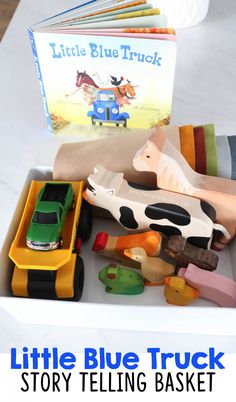 the little blue truck story telling basket is filled with toys and books for toddlers to read