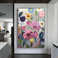 an abstract floral painting hangs on the wall