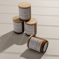 three jars with labels on them sitting next to each other