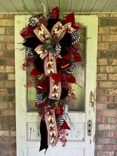 a red and black wreath on the front door