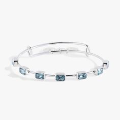 Whether you're commemorating a March birthday or you're drawn to the courage and happiness of the aquamarine-colored crystal, the Emerald-Cut Birthstone Bangle will add personalized elegance to your stack. This birthstone bangle features seven emerald-cut aquamarine blue crystals on an expandable wire bangle in a shiny gold or silver finish. Adjustable Turquoise Bracelet With Birthstone, Adjustable Silver Aquamarine Bracelet, Modern Aquamarine Birthstone Jewelry, Adjustable Aquamarine Silver Bracelet, Adjustable Silver Aquamarine Bracelets, Modern Adjustable Birthstone Jewelry, Adjustable Birthstone Bangle Bracelet, Adjustable Aquamarine Jewelry As Gift, Adjustable Bangle Bracelet With Birthstone