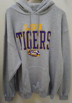 Champion LSU Tigers Mens Grey Name Drop Long Sleeve Hoodie - 14754287 Game Day Fan Apparel Tops With Drawstring Hood, Winter Fan Apparel Hoodie In Athletic Heather, Winter Sports Fan Merchandise Hoodie, Cotton Team Spirit Hoodie For Fan Merchandise, Casual Football Season Fan Gear Hoodie, Casual Hoodie For Football Season Fan Gear, Athletic Heather Sweatshirt For Sports Fan Gear, Winter School Spirit Sweatshirt For Fan Gear, Winter School Spirit Sweatshirt For Fans