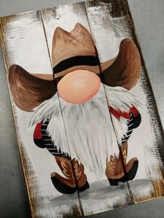 a wooden sign with an image of a gnome wearing boots and a cowboy hat on it