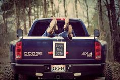 a man laying down in the back of a truck with his feet up on the bed