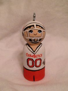 a ceramic ornament with a football player on it's face and name