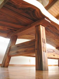 a wooden bench sitting on top of a hard wood floor