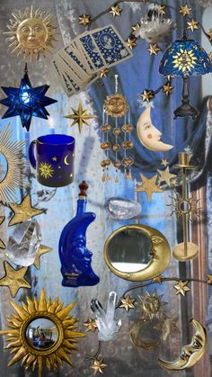 an assortment of decorative items on display in a glass case with blue and gold accents