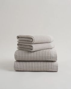 three white towels stacked on top of each other