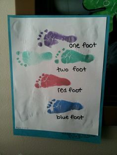 a child's handprinted sign with footprints and words that read, one foot two foot red foot blue foot