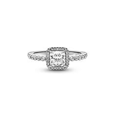 a white diamond ring with diamonds on the sides and an halo setting in the middle