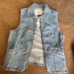 American Eagle Zip Up Vest Never Worn. Has Stretch. Fit Is Xxs But Can Fit S. Casual Light Wash Vest For Fall, Trendy Light Wash Vest For Fall, Blue Spring Vest With Pockets, Spring Utility Fitted Vest, Fitted Utility Vest For Spring, Blue Utility Top For Spring, Blue Utility Tops For Spring, Zip Up Vest, American Eagle Outfitters