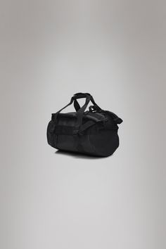 Texel Duffel Bag Mini is compact, yet carefully designed for unparalleled functionality when traveling in any weather. Don't underestimate Texel Duffel Bag Mini's compact proportions -- it's been carefully designed for traveling, even if that's just a daily commute. The duffel bag is characterized by a cylindrical profile with a U-shaped flap and zip closure. It has a generous opening for fuss-free packing, a single main compartment and boasts three internal mesh pockets. The duffel also feature Black Rectangular Duffle Bag With Removable Pouch, Black Travel Duffle Bag With Detachable Handle, Functional Black Nylon Duffle Bag, Black Nylon Sports Duffle Bag, Black Nylon Functional Duffle Bag, Pu Fabric, Duffel Bags, Duffel Bag, Weekender Bag