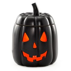 a black pumpkin container with glowing eyes on it's face and the lid is open