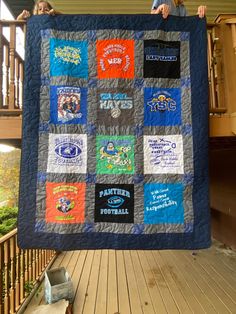 two boys holding up a quilt made with t - shirts on the front and back