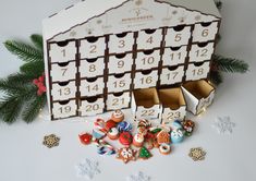 a wooden calendar with christmas decorations around it