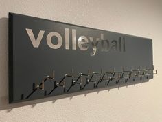 there is a sign that says volleyball hanging on the wall