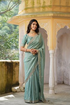 Gorgeous sea green tussar georgette saree is a perfect choice for weddings and festive occasions!. It has an embroidered border and comes with a beautiful embroidered blouse. Disclaimer: The actual product may vary slightly from the image. These are custom orders, hence expect slight variation in color, placement of the motif or buta. ESTIMATED DELIVERYBecause this is a custom order, it would take about 4 weeks from the date of purchase. RETURN POLICYThis product is a custom order and cannot be returned or exchanged. Reception Saree With Embroidered Border In Chinon, Chinon Saree With Embroidered Border For Reception, Reception Saree With Embroidered Border, Wedding Pre-draped Saree With Embroidered Border In Slub Silk, Pista Green Saree With Embroidered Border, Pista Green Saree With Embroidered Border For Diwali, Festive Pista Green Saree With Embroidered Border, Green Embroidered Border Saree For Reception, Green Sharara With Embroidered Border For Wedding