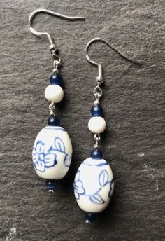 Unusual, stylish handmade earrings, made using upcycled vintage glass beads. I source old, unloved vintage jewellery, and repurpose the beads, giving them a new lease of life! These are very stylish, made with patterned ceramic barrel shaped beads, topped with coordinating white ceramic and blue glass beads. They look elegant and sophisticated, with a quirky vintage style. These earrings, as with all of my designs, are one-off creations; I never repeat a design exactly, so you can be sure of a t Quirky Jewelry Handmade, Vintage White Flower Drop Earrings, White Czech Glass Beaded Earrings, Vintage White Dangle Flower Earrings, White Bohemian Earrings With Czech Glass, Vintage White Beaded Earrings, Quirky Jewelry, Quirky Earrings, Earrings Flower