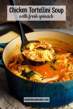 chicken tortellini soup with fresh spinach in a blue pot