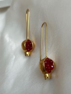 This allergy-free jewelry is 18K-24K gold plated. We produce our jewelry in our workshop in Istanbul.   We use precious stones and brass in our products. Since the stones are natural, they may have different shapes and colors, but this does not spoil their appearance.  We recommend that you remove your jewelry in the shower to ensure longer wear, and we also recommend that you avoid contact of the jewelry with perfume or other cosmetic products.  We package your jewelry in stylish boxes and send Gold Garnet Earrings As Gift, Yellow Gold Garnet Earrings For Gift, Faceted Garnet Earrings In Gold, Gold Faceted Garnet Earrings, Gold Faceted Ruby Earrings, Gold Garnet Faceted Earrings, Gold Garnet Earrings For Wedding, Pomegranate Jewelry, Pomegranate Design