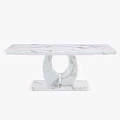 a white marble table with an oval base on the top and a circular design at the bottom