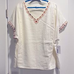 This Shirt Is So Cute With Matching Embroidery On Neckline Same As Sleeves. Bodice Top Goes Across Back And Through Shirt Sleeve As You Can See In The Picture. This Is Cute With Jeans Especially If You Coordinate The Color With The Embroidery. Throw On A Leather Wrap Bracelet To Add A Touch Of Pizzazz. Nwt. Easy Care Instructions. Comfort Is Always Key! Embroidered V-neck Peasant Top For Beach, Folk Style V-neck Beach Top, Peasant Style Beach Top With Embroidered Hem, Peasant Top With Embroidered Hem For The Beach, Peasant V-neck Top For Vacation, Folk Style Vacation Tops With Embroidered Hem, Folk Tops With Embroidered Hem For Vacation, Folk Style Tops With Embroidered Hem For Vacation, Peasant Style Tunic Top For Vacation