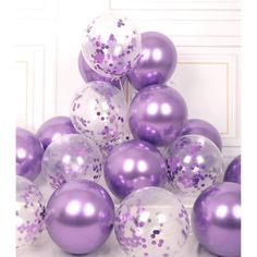 a bunch of purple and white balloons with confetti on them