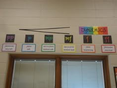 there are many different types of magnets on the wall above the windows in this classroom