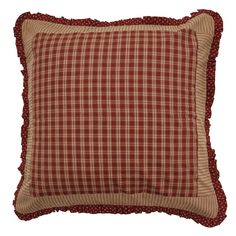 a red and white plaid pillow with ruffle trim on the bottom, sitting on a white background