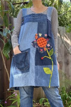 a woman wearing an apron with flowers on it