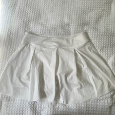 White Nike Tennis Skort. Built In Shorts, Dri-Fit Material. Size Medium, Never Worn. Nike Stretch Short Skort, Nike Casual Short Tennis Skirt, Nike Casual Tennis Skirt, Nike White Fitted Tennis Skirt, Fitted White Nike Tennis Skirt, Nike White Tennis Skirt For Spring, Nike White Casual Skort, Stretch White Pleated Bottoms, White High Waist Pleated Shorts