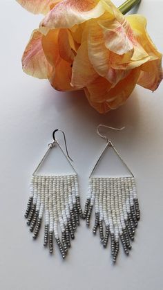 Our friend Amy recently had a birthday. I made these for Amy for her birthday. You now can also own a pair of these birthday earrings for yourself. This is exciting if you like these earrings. Amy won't mind that I put them on here to sell, because Amy is awesome and super sweet. As you can see, they are lovely neutral colors. Woven onto a silver triangle, finished with sterling silver ear wires. Made to order. Not available for wholesale. Handmade Drop Earrings For Birthday, White Bohemian Jewelry For Birthday, Bohemian White Jewelry For Birthday, Handmade Dangle Earrings For Birthday, Adjustable White Beaded Earrings With Silver Beads, Nickel-free White Beaded Earrings, White Silver Beaded Drop Earrings, White Nickel-free Beaded Earrings, Handmade White Jewelry For Birthday