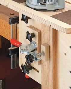 a work bench with tools attached to it and a router on the table next to it