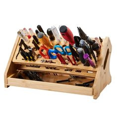 a wooden drawer with scissors and other tools