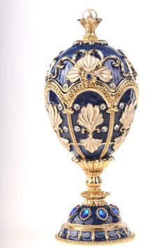 an ornate blue and gold urn on a white background with the words, ` person'written below it