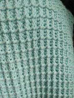 a close up view of a crocheted blanket