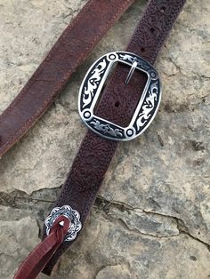 "Hand made 1.5\" wide headstall with buckle. These headstalls are made in our shop and are made to order. Buckles may vary as inventory changes and new styles are released. They are made from Heavy 14/16 ounce Herman Oak leather. Embossed with the Western Floral, Basketweave, Plain, and soon barbwire. Jermiah Watt Hardware is used and is top quality stainless steel hardware. These headstall get compliments wherever you go and a great using piece of tack." Rustic Concho Belt Buckles For Rodeo, Adjustable Western Concho Belt Buckles, Rustic Adjustable Brown Belt Buckles, Rustic Hand Tooled Adjustable Belts, Western Style Adjustable Belts For Western-themed Events, Adjustable Brown Rustic Belt Buckle, Adjustable Rustic Brown Belt Buckle, Adjustable Concho Belt Buckles For Western-themed Events, Rustic Hand Tooled Belt Buckles For Western Events