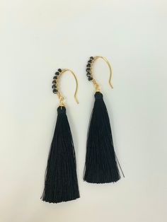 These handmade earrings, are wrapped with gold plated wire and 3mm faceted black Czech crystals forming a eye-catching arc which hangs a black color silk tassel. The earrings are 3.74 inches long, if you would like shorter size, I will custom make your order. They are very light weight (0.08oz/2.2grams each one). These are perfect for summer, nights out or wedding occasion! All Items are lovingly packaged in a jewelry box ready for gifting. Inside of the box's lid, you will find a care instructions, also you will receive a cleaning cloth to keep your pieces looking shiny and new. If this item is a gift and you would like to include a note, please add it in the "note" box at checkout. **Please avoid water, perfume, deodorants or any other liquid on the product, which may harm the materials* Black Tassel Earrings With Ear Wire As A Gift, Water Perfume, Note Box, Wire Wrapped Earrings, Czech Crystal, Tassel Earrings, Wedding Earrings, Summer Nights, Cleaning Cloth