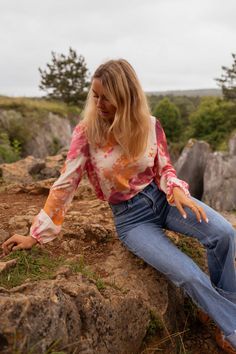 Easily adjust and tie the open back with a drawstring for a customizable look. The vibrant orange patterns add a touch of fun and playfulness to this crewneck blouse with long sleeves. The elastic wrists provide a comfortable fit while the blouse remains unlined and not sheer. Ophelie is also wearing the Blue Maddie Jeans Sizes: S-M / M-L S-M: Length 21.3 in - Width 18.1 in M-L: Length 22.0 in - Width 18.9 in 40% Viscose - 20% Polyamide Washing: handwash Multicolor Tops With Elastic Sleeves For Spring, Pink Long Sleeve Tops With Elastic Sleeves, Casual Long Sleeve Blouse With Elastic Sleeves, Casual Long Sleeve Tops With Elastic Sleeves, Casual Multicolor Tops With Blouson Sleeves, Casual Orange Stretch Blouse, Casual Stretch Orange Blouse, Multicolor Long Sleeve Tops With Blouson Sleeves, Multicolor Blouson Sleeves Top For Fall