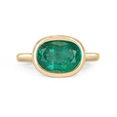 Displayed is a medium-dark green Colombian emerald, solitaire, oval cut bezel ring in 14K yellow gold. This gorgeous solitaire ring carries a full 2.68-carat emerald in a sleek bezel setting. The emerald has incredible clarity and luster. This emerald has a great spread along with unique clarity that will have you captivated at first glance. This is an ideal engagement ring or right-hand ring! Setting Style: Solitaire / Bezel Setting Material: 14K Yellow Gold Gold Weight: 4.1 Grams Main Stone: E Oval Emerald Birthstone Ring In Fine Jewelry Style, Yellow Gold Emerald Ring With Oval Cabochon, Yellow Gold Emerald Ring Oval Cabochon, Oval Polished Emerald Ring In 14k Gold, Oval Emerald Ring With Polished Finish In 14k Gold, Oval Emerald Ring In 14k Gold With Polished Finish, Oval Emerald Ring With Bezel Setting, Oval Emerald Ring With Polished Finish In Yellow Gold, Oval Yellow Gold Emerald Ring With Polished Finish