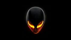 an alien head in the dark with glowing eyes and yellow light on it's face